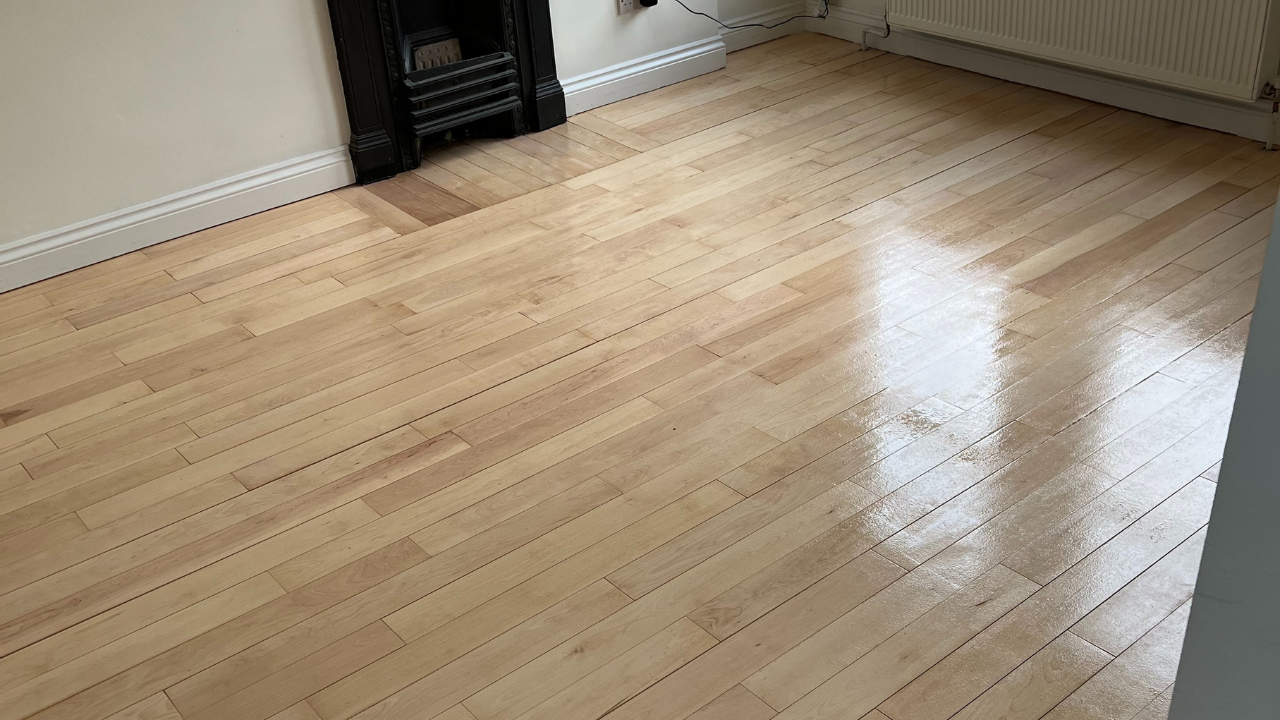 Wood Floor Sanding in New Southgate on a solid maple strip hardwood floor, newly sanded and lacquered to a smooth, glossy finish.