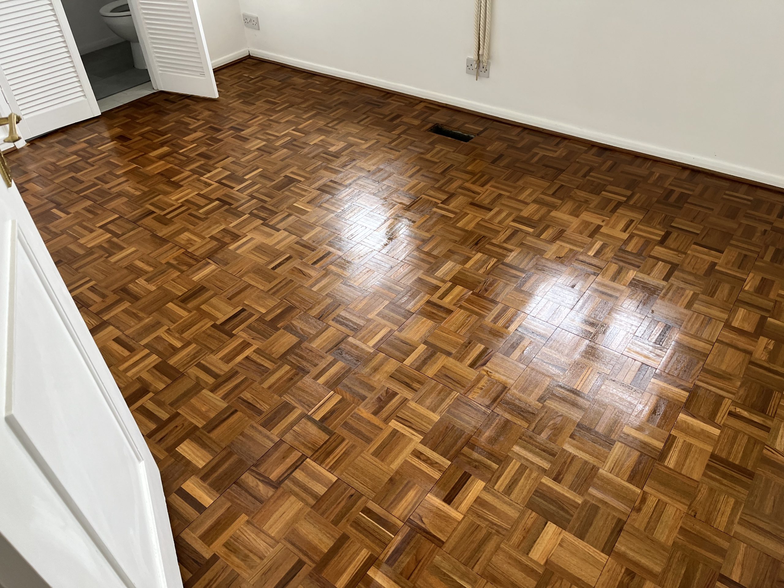 Wood Floor Sanding in New Southgate on a restored oak finger-block parquet bedroom floor with a smooth, glossy finish.