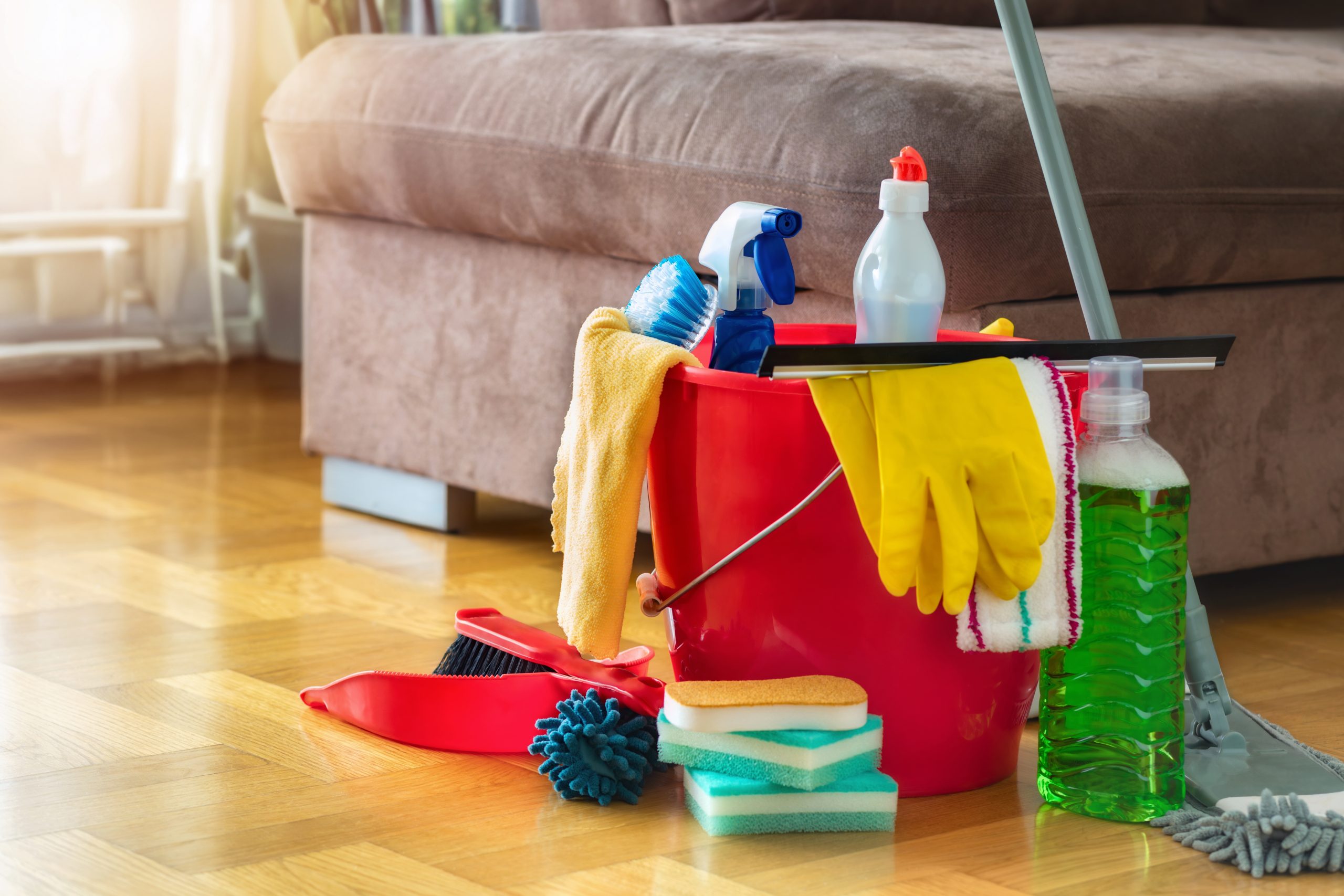 After Wood Floor Sanding in New Southgate, cleaning products sit on a polished oak herringbone parquet floor ready for gentle maintenance.