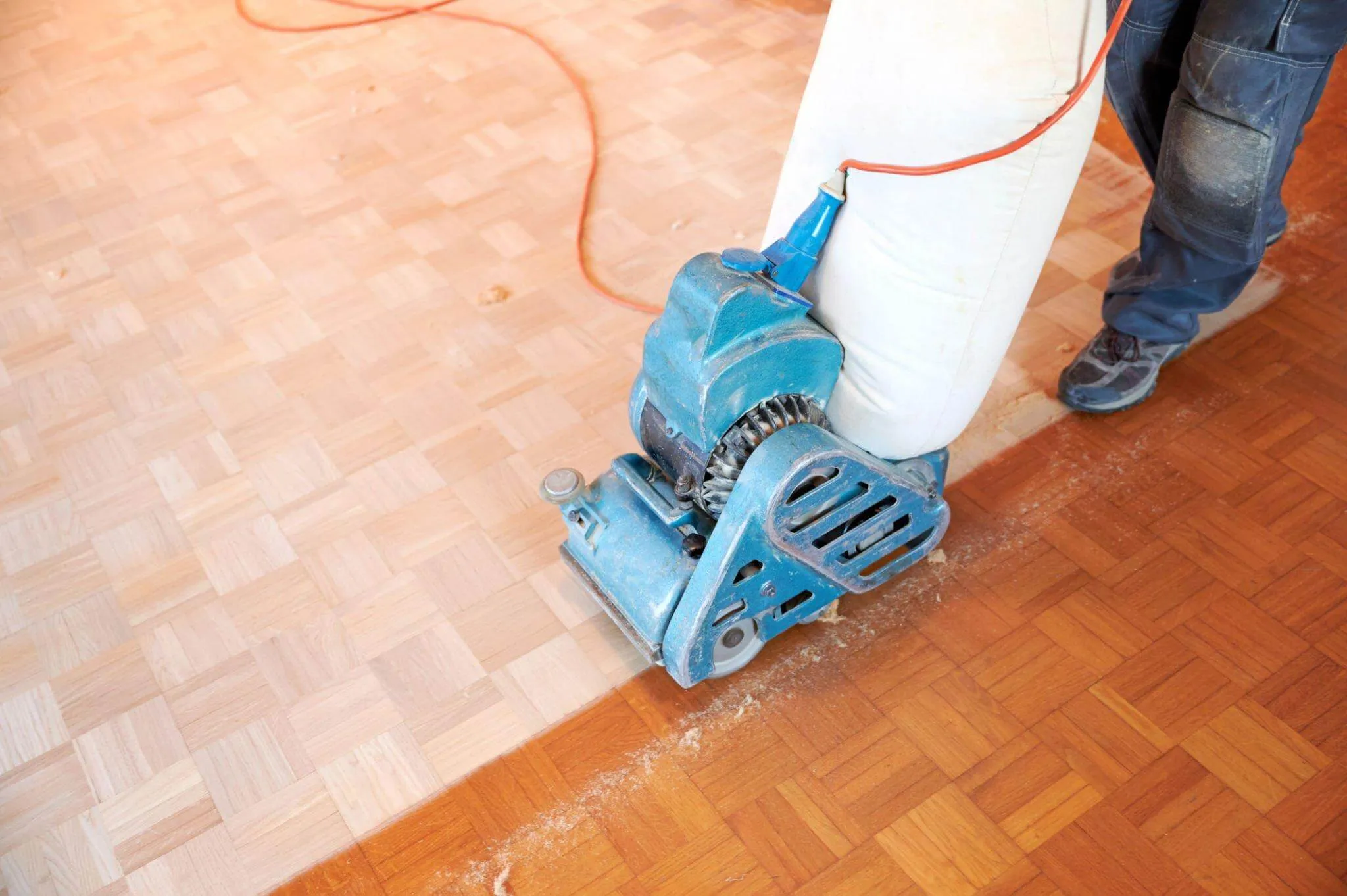 Wood Floor Sanding in New Southgate on an oak mosaic parquet floor, showing a drum sander stripping the old finish to reveal fresh timber.