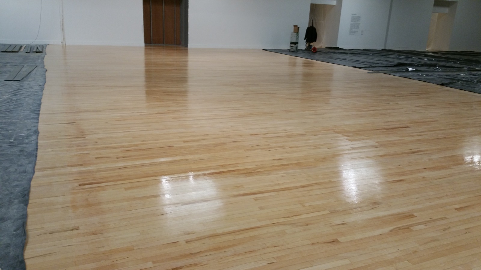 Commercial Floor Sanding in New Southgate on a maple hardwood strip hall floor, fully sanded and sealed to a smooth, glossy finish.