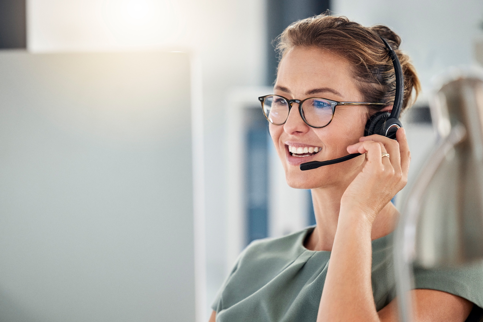 Friendly customer service agent discussing Commercial Floor Sanding in New Southgate for an oak hardwood commercial floor, speaking with a client by headset.