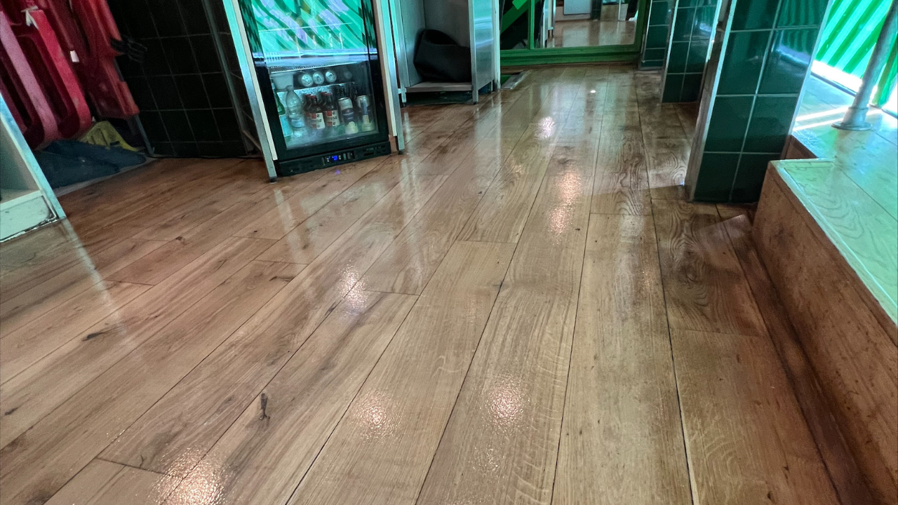 Commercial Floor Sanding in New Southgate on an oak plank hardwood shop floor, freshly sanded and sealed for a smooth, glossy finish.