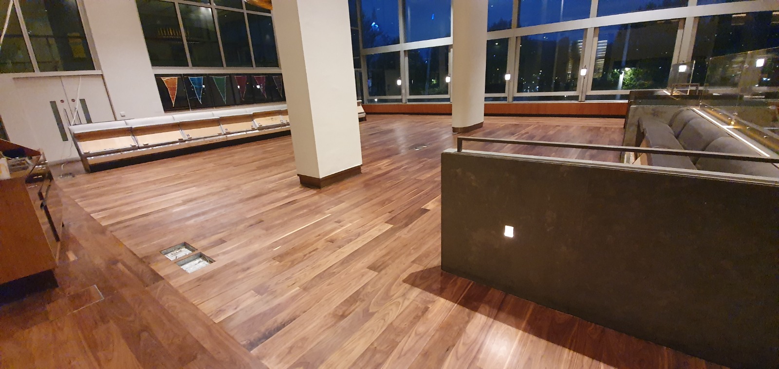 Commercial Floor Sanding in New Southgate on a rich walnut engineered wood restaurant lounge floor, restored to a deep, even sheen.